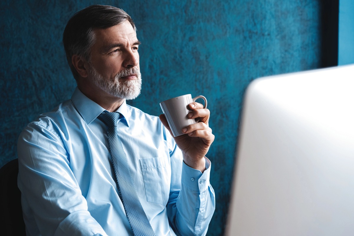 Mature man working on computer in office